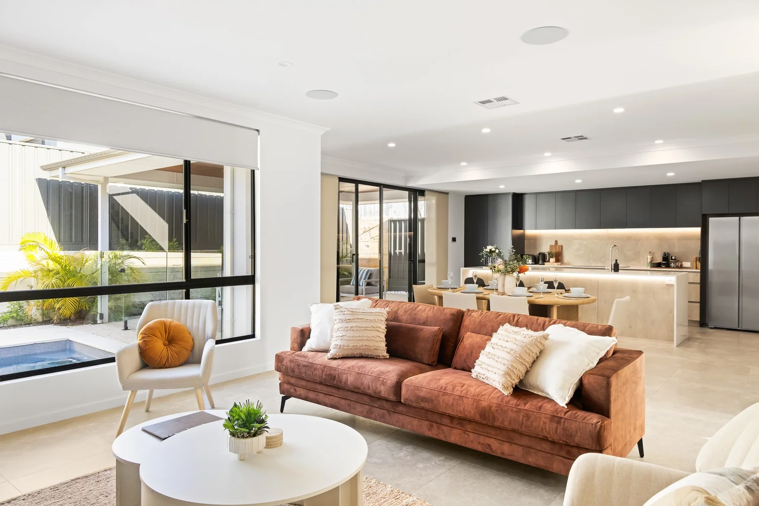 Open-plan living opening to the pool at The Scarborough Mirage